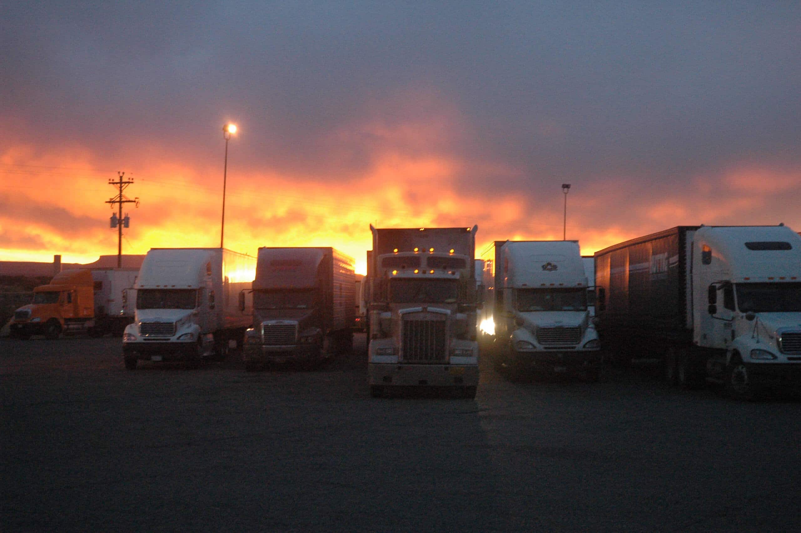 trucks parked with sunset behind